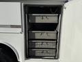 A 2009 Ford F-550 with open compartments featuring multiple stacked drawers for storage