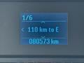 A digital display showing vehicle information with readings of 110 kilometers to empty and an odometer reading of 80573 kilometers