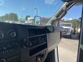 Interior view of a 2020 Chevrolet Express dashboard featuring controls and a digital display