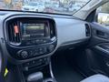 Interior view of a 2018 Chevrolet Colorado showcasing the dashboard with a touchscreen display and control buttons