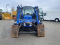 A blue 2016 New Holland T475 tractor with a front loader attachment and two large dirt buckets is shown facing forward