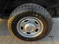 A close-up of a 2012 Ford F-250 tire and steel wheel with a tire tread pattern and the brand name visible on the sidewall