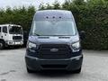 A 2017 Ford Transit 350 with a dark blue exterior and a black front grille featuring the Ford logo and visible headlights