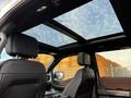 Interior view of a 2021 Ford F-150 showing leather seats and a panoramic sunroof