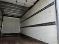 Interior of a 2019 Hino 195 box truck featuring a spacious cargo area with metal straps along the walls for securing loads