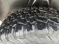 Close-up of the rugged tire tread of a 2015 RAM 1500 showcasing deep grooves and an aggressive pattern for off-road performance