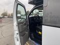 A 2017 Chevrolet Express with an open driver door showing the steering wheel and dashboard controls