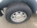 A close-up view of a tire from a 2013 Ford F-150 showcasing the tread pattern and wheel rim