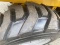 Close-up of a thick tire from a 2024 AGT KRW 23 Mini loader with a rugged tread pattern designed for traction on various terrains