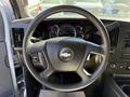 Steering wheel of a 2021 Chevrolet Express with a logo in the center and control buttons on the side