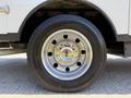Close-up of a 2023 Ford F-550 wheel featuring a chrome hubcap and black rubber tire with visible tread pattern