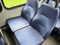 Two blue fabric seats in a Chevrolet Express van with a textured design