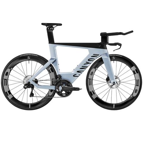2025 Canyon Speedmax CF SLX 8 Di2 Vanquish Road Bike in a light blue and black color scheme featuring aerodynamic design and high-performance components