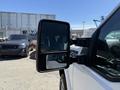 A 2014 Ford F-250 SD with a side mirror showing two reflective surfaces one for standard view and one for a wider angle view