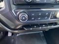Dashboard controls of a 2014 GMC Sierra 1500 featuring climate control knobs and buttons for air conditioning and ventilation settings