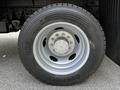 The image shows a close-up of a tire mounted on a 2016 Ford F-550 featuring a silver rim and a wide tread designed for heavy-duty performance