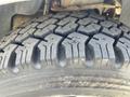 Close-up of a rugged tire from a 2012 Ford F-150 showing deep treads and textured surface