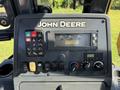 Control panel of a 2013 John Deere 710K featuring various buttons gauges and knobs for operation