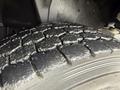 Close-up of a tire tread from a 2016 International CE300 showcasing deep grooves and a textured surface typically found on vehicle tires