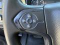 Close-up of the steering wheel controls in a 2016 GMC Sierra 1500 featuring buttons for setting and adjusting cruise control settings