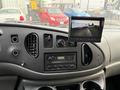 Dashboard of a 2007 Ford E-350 featuring a stereo system and a monitor displaying a rearview camera image