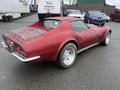 A red 1970 Chevrolet Corvette with a distinctive rear design and chrome accents visible on the back and wheels