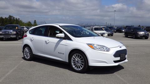 A white 2016 Ford Focus parked with its front angled towards the viewer showcasing its sleek design and distinct grille