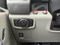 Interior controls of a 2018 Ford F-150 including knobs for lighting and climate settings along with red buttons and a pull switch