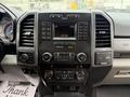 The dashboard of a 2019 Ford F-350 SD featuring a central display screen with audio controls and air conditioning knobs