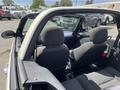 Interior view of a 2005 Chrysler PT Cruiser showing two grey front seats and two grey rear seats with an open roof design