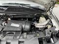 Close-up of the engine compartment of a 2019 Chevrolet Express showcasing the Vortec engine components and various mechanical parts