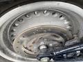 Close-up of a 2008 Harley-Davidson FLSTFI's rear wheel with a shiny disc brake and a black swingarm
