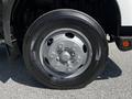 Close-up of a silver wheel with five bolts and a black tire on a 2020 Hino 155