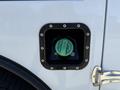 A close-up of a fuel filler neck for a 2023 Ford F-550 featuring a green diesel fuel cap