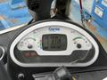 A close-up of a Genie GTH-5519 display panel showing engine RPM and other gauges with a cracked screen and control knobs visible