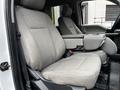Two grey cloth seats of a 2020 Ford F-350 SD with a center console in between them