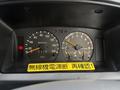 Dashboard of a 2001 Toyota Dyna featuring speedometer and fuel gauge with warning lights and stickers