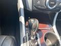 Close-up of the gear shift and console of a 2017 Acura TLX showcasing the stylish design and materials used in the interior
