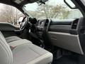 The interior of a 2017 Ford F-550 featuring gray cloth seats and a modern dashboard with various controls and a console between the front seats