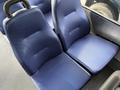 Blue upholstered seats in a 2019 Chevrolet Express van with a textured surface and a simple design