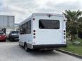 A white 2020 Chevrolet Express bus is parked with its rear visible featuring large windows and signage that reads NOT