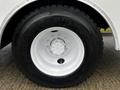 A close-up view of a white tire from a 2013 International DuraStar with a Goodyear logo on the sidewall and a silver wheel rim