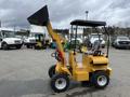 A yellow 2024 AGT Industrial KRW23 Mini Loader with a front bucket and a cabin featuring a seat and steering wheel