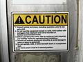 A 2016 Ford F-550 with a caution sign detailing safety instructions for operating a crane on the vehicle