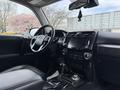 Interior view of a 2021 Toyota 4Runner showing the steering wheel dashboard and center console with black leather seats