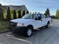 A 2008 Ford F-150 XL in white with a black front bumper and wheel rims facing slightly to the right