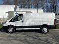 2017 Ford Transit cargo van in white with black trim parked on a concrete surface