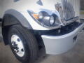 A 2016 International WorkStar 7500 truck featuring a chrome grille round headlights and a distinctive front bumper design
