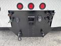 The rear view of a 2013 Kenworth T370 showing various connectors and hooks used for towing and trailer connections