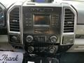 The dashboard of a 2018 Ford F-550 featuring a central display panel with buttons for audio and climate control